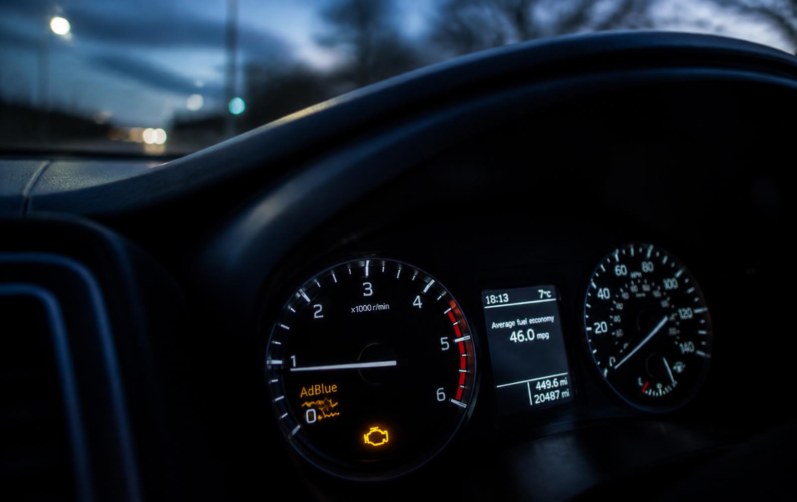 AdBlue warning light and engine management light illuminated on a diesel car dashboard